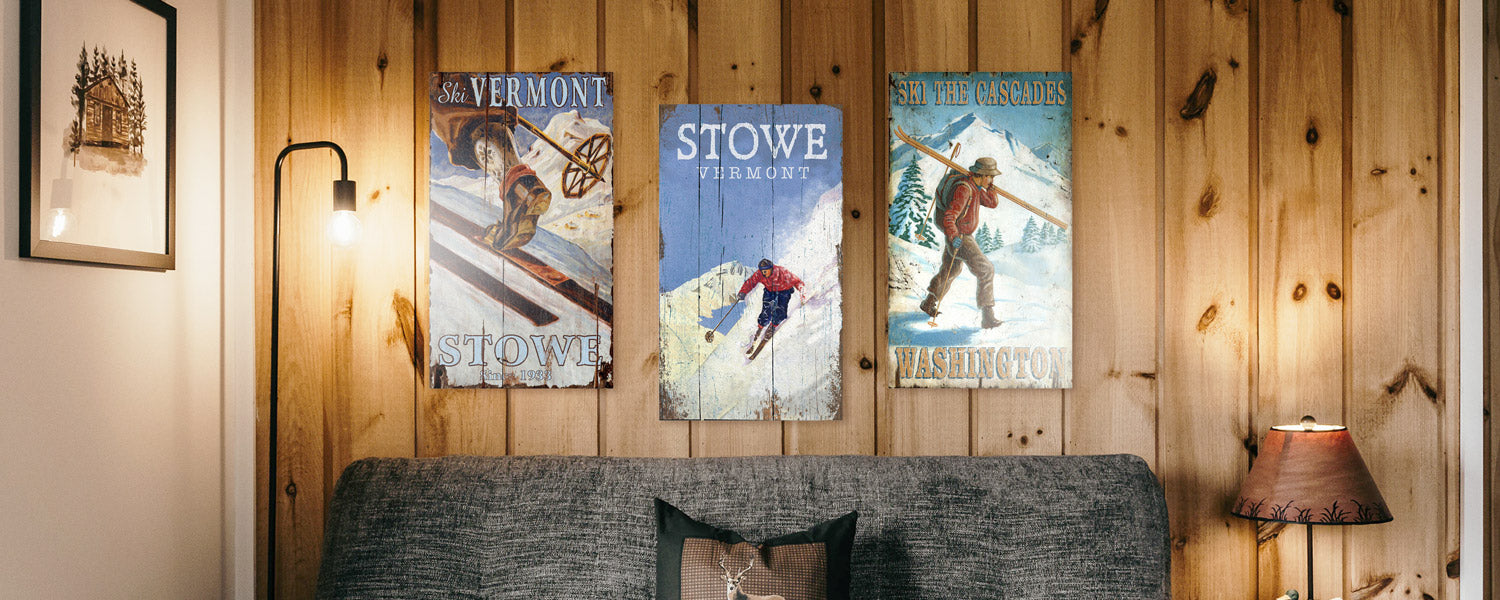 Ski and Snow themed wood signs in a rustic bedroom with wood wall paneling